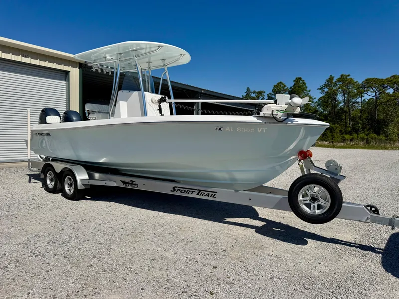 Slide: The Image of 2023 Contender 24S boat on a Sport Trail trailer, parked outdoors. - 1