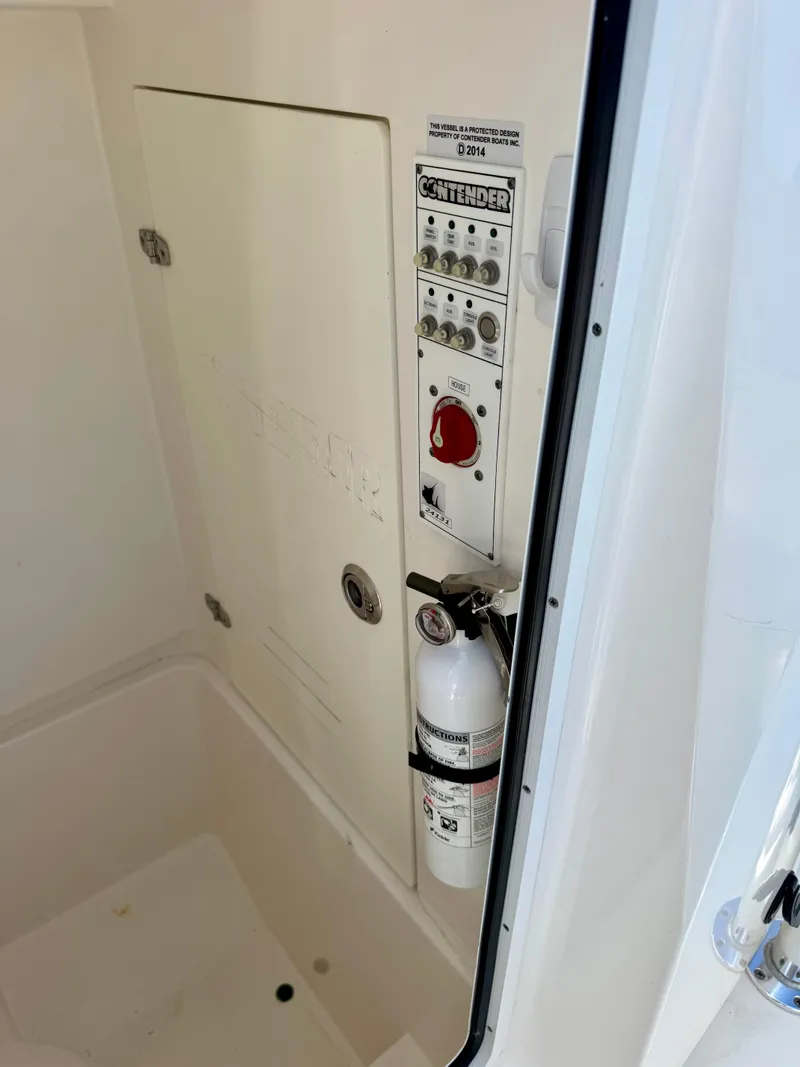 Slide: The Image of Control panel and fire extinguisher on 2023 Contender 24S boat. - 10