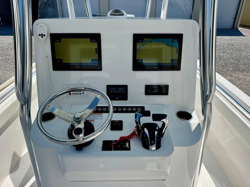 Slide: The Image of 2023 Contender 24S boat console with dual screens, steering wheel, and controls. - 13