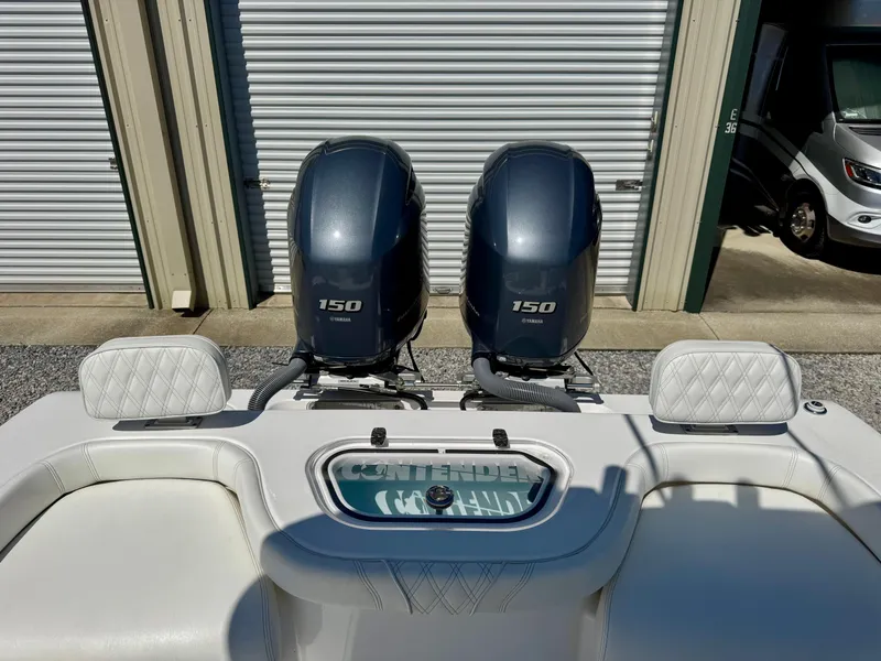 Slide: The Image of 2023 Contender 24S boat with dual 150 horsepower engines, white seating, and storage units. - 15