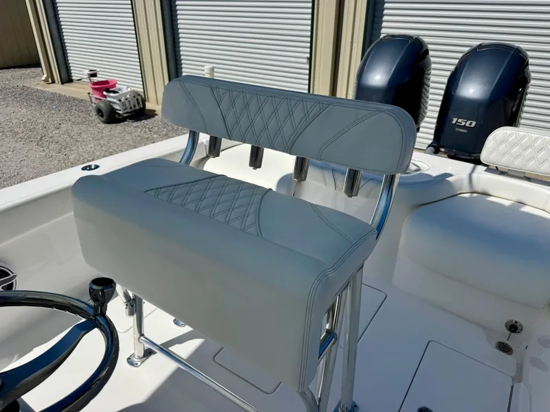 Slide: The Image of 2023 Contender 24S boat interior with dual engines and cushioned seating. - 16