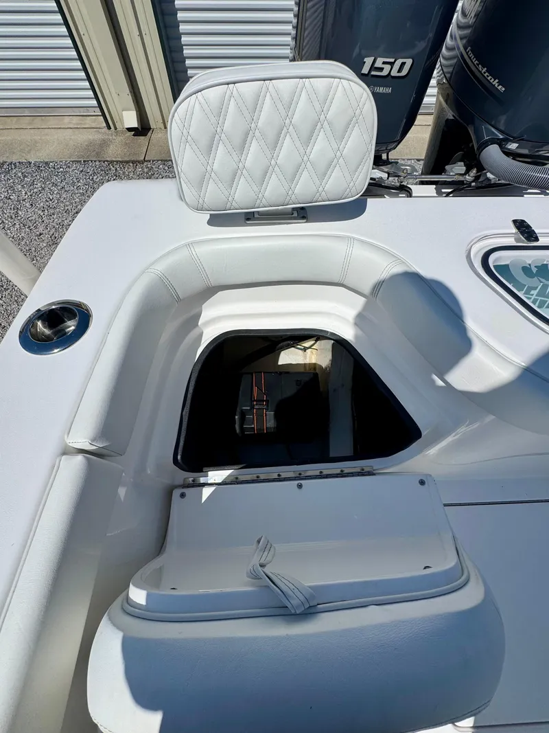 Slide: The Image of 2023 Contender 24S boat interior with open storage compartment and white cushioned seating. - 21