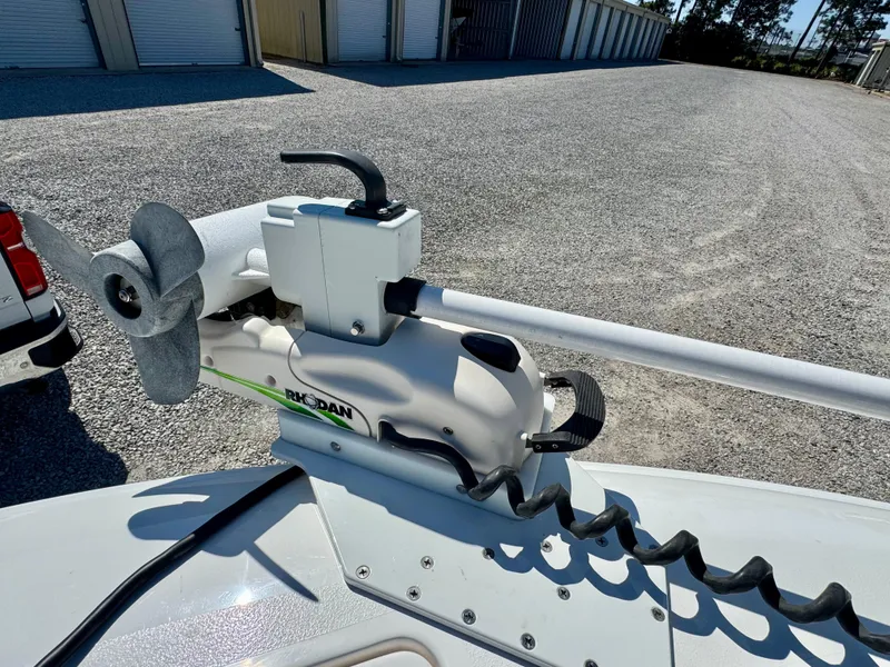 Slide: The Image of 2023 Contender 24S boat with a mounted trolling motor in a storage area. - 7