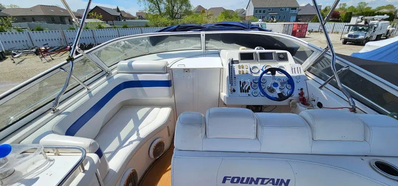 Slide: The Image of 2002 Fountain 38 Express Cruiser interior with white seating and control panel. - 12