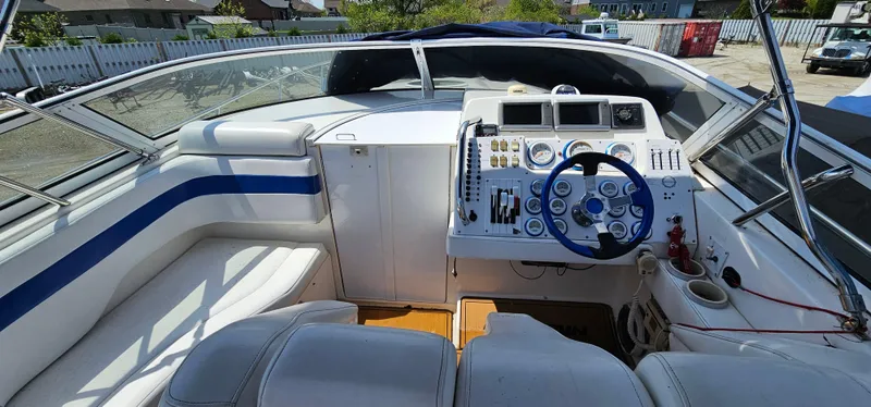 Slide: The Image of 2002 Fountain 38 Express Cruiser cockpit with steering wheel and control panel. - 13