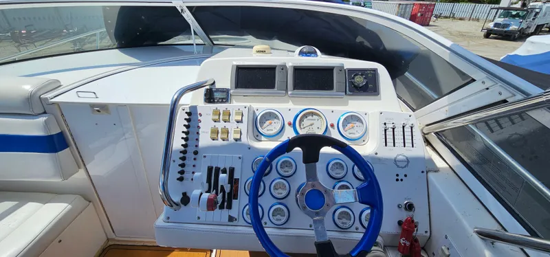Slide: The Image of 2002 Fountain 38 Express Cruiser dashboard with gauges and blue steering wheel. - 16
