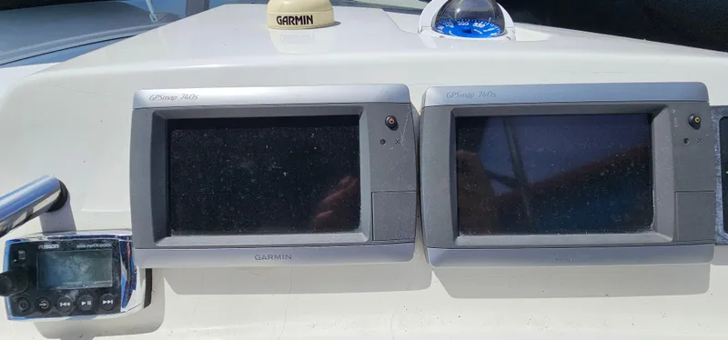 Slide: The Image of Dashboard of a 2002 Fountain 38 Express Cruiser with Garmin navigation displays. - 17