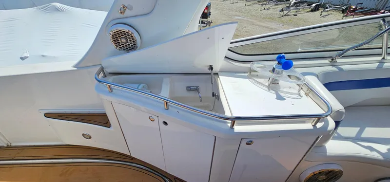 Slide: The Image of 2002 Fountain 38 Express Cruiser yacht deck with sink and storage area. - 20
