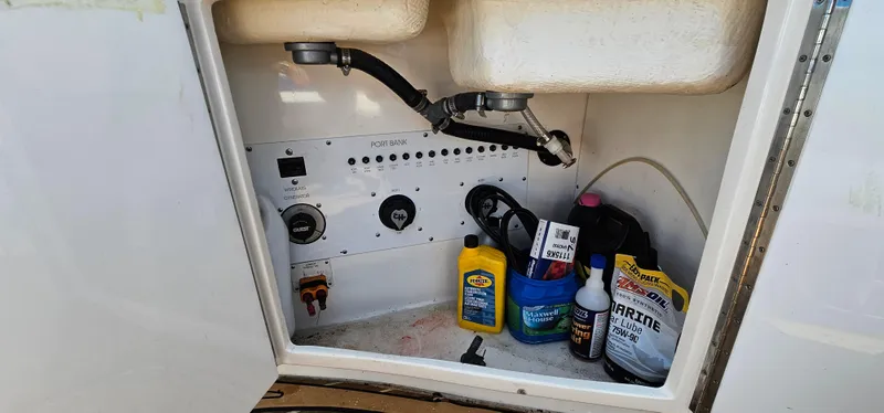 Slide: The Image of Storage compartment of a 2002 Fountain 38 Express Cruiser with maintenance supplies. - 24