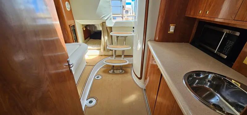 Slide: The Image of Interior of 2002 Fountain 38 Express Cruiser with kitchenette and seating area. - 32