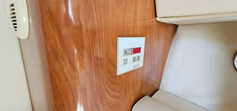 Slide: The Image of Wooden interior panel with control switch on 2002 Fountain 38 Express Cruiser. - 35