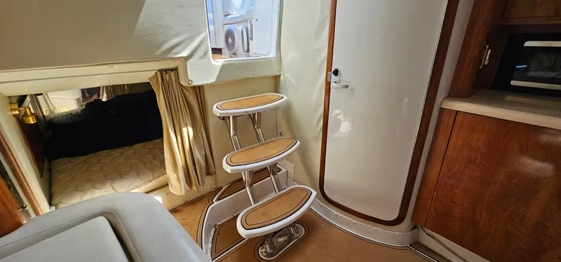 Slide: The Image of Interior of 2002 Fountain 38 Express Cruiser with stairs, cabin, and wooden cabinetry. - 36