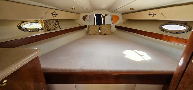 Slide: The Image of Interior cabin of 2002 Fountain 38 Express Cruiser with bed and portholes. - 39