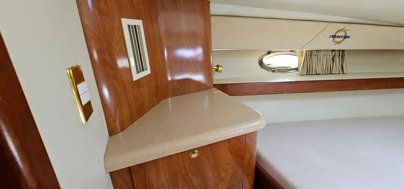 Slide: The Image of Interior of 2002 Fountain 38 Express Cruiser with wood cabinetry and porthole window. - 40