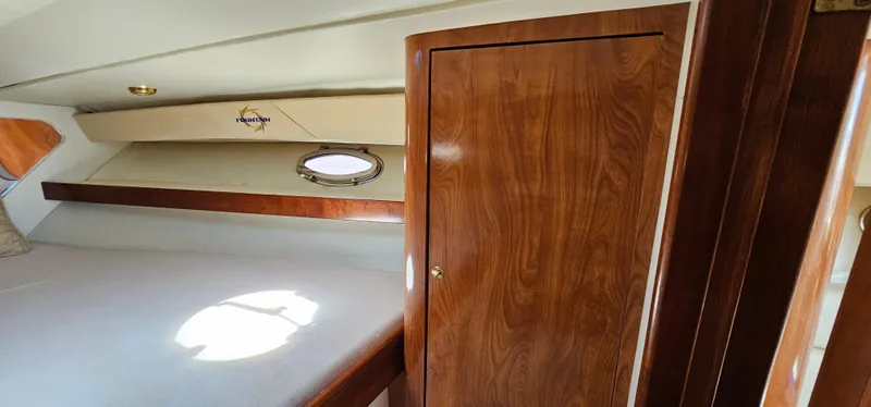 Slide: The Image of Interior cabin of 2002 Fountain 38 Express Cruiser with wood paneling and porthole window. - 41