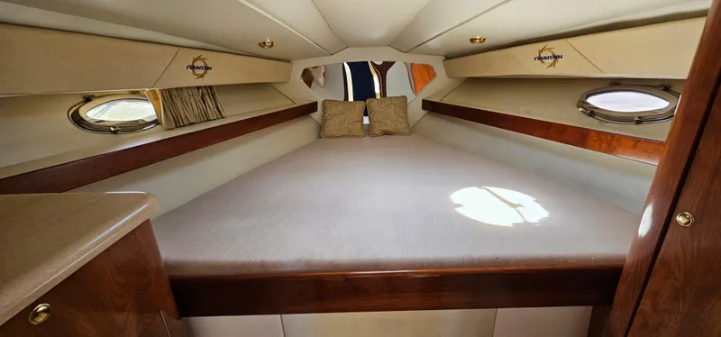 Slide: The Image of Interior cabin of 2002 Fountain 38 Express Cruiser with cozy bed and portholes. - 42