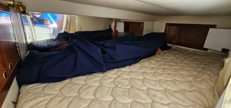 Slide: The Image of 2002 Fountain 38 Express Cruiser cabin interior with bed and storage cabinets. - 45