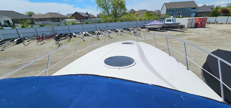 Slide: The Image of 2002 Fountain 38 Express Cruiser in storage yard, surrounded by boats and vehicles. - 46