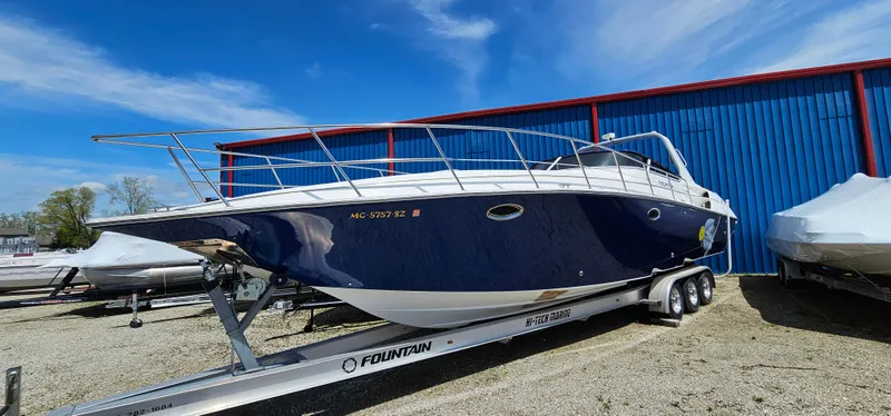 Slide: The Image of 2002 Fountain 38 Express Cruiser on trailer, parked outdoors under blue sky. - 5