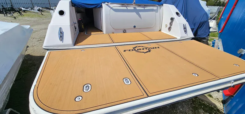 Slide: The Image of 2002 Fountain 38 Express Cruiser swim platform with teak decking and logo. - 7