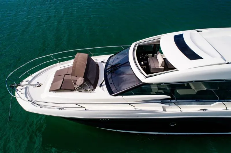 Slide: The Image of Luxurious 2019 Prestige 520S yacht cruising on clear turquoise waters. - 13