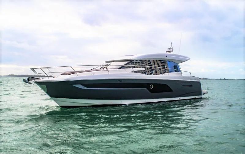 Slide: The Image of 2019 Prestige 520S yacht cruising on open water under cloudy skies. - 4