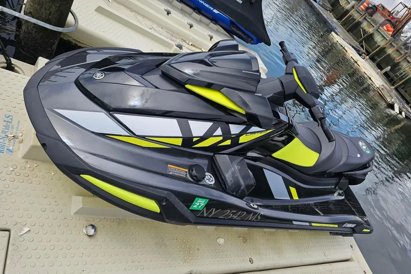 Slide: The Image of 2021 Yamaha WaveRunner VX Limited Ho on dock, sleek black and yellow design. - 6