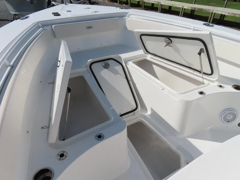 Slide: The Image of 2024 Sea Hunt Gamefish 25 boat with open storage compartments on deck. - 10