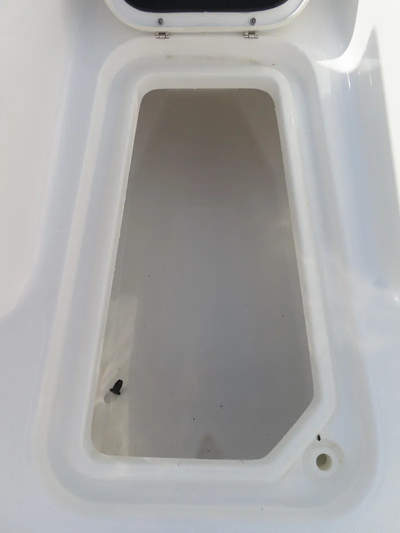 Slide: The Image of 2024 Sea Hunt Gamefish 25 storage compartment, open and empty, with white interior. - 11