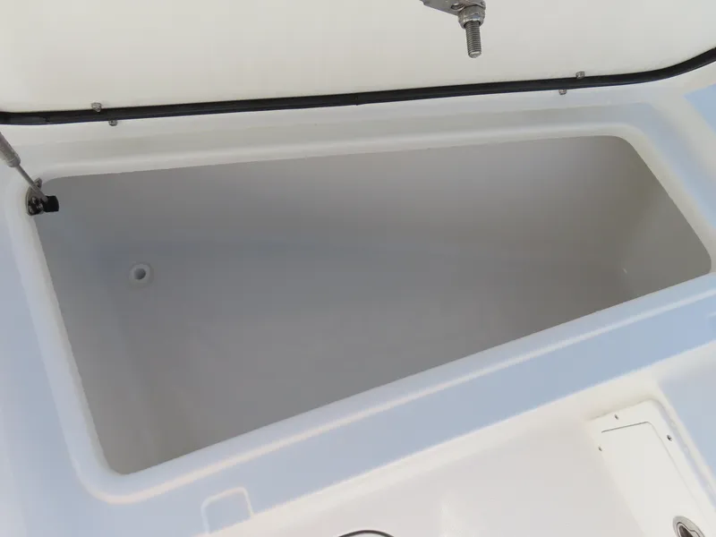 Slide: The Image of 2024 Sea Hunt Gamefish 25 storage compartment, open and empty, showcasing interior space. - 12