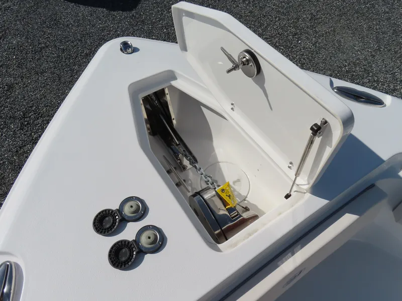 Slide: The Image of 2024 Sea Hunt Gamefish 25 anchor compartment with open hatch and winch system. - 16