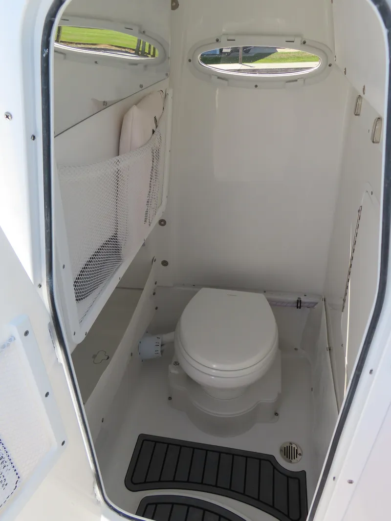 Slide: The Image of 2024 Sea Hunt Gamefish 25 boat interior with compact marine toilet. - 21