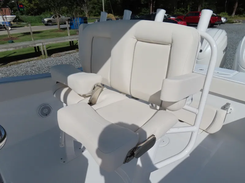 Slide: The Image of 2024 Sea Hunt Gamefish 25 boat seating with cushioned armrests and white upholstery. - 24