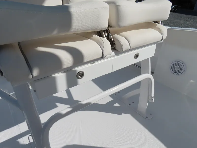 Slide: The Image of 2024 Sea Hunt Gamefish 25 boat seating with white cushions and storage compartment. - 25
