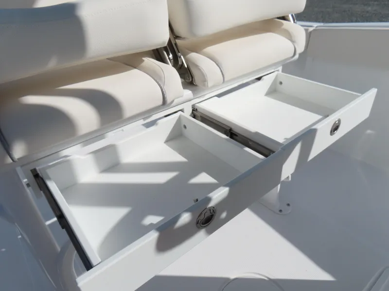Slide: The Image of 2024 Sea Hunt Gamefish 25 boat with open storage compartments under cushioned seats. - 26