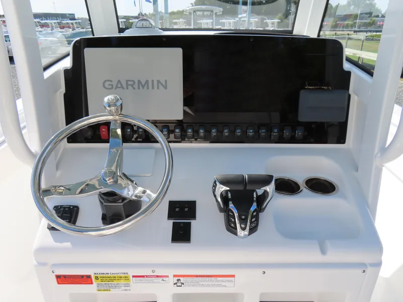 Slide: The Image of 2024 Sea Hunt Gamefish 25 helm with Garmin display and steering wheel. - 28