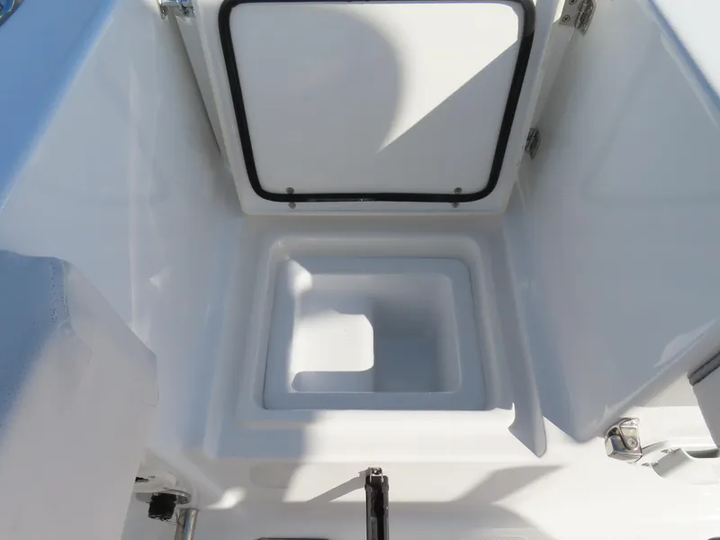 Slide: The Image of 2024 Sea Hunt Gamefish 25 storage compartment with open lid, showcasing interior space. - 35