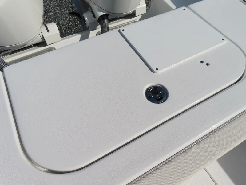 Slide: The Image of 2024 Sea Hunt Gamefish 25 boat deck with storage compartment and engine details. - 36