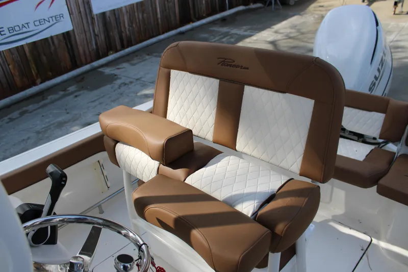 Slide: The Image of 2025 Pioneer 222 Islander boat with brown and white cushioned seating. - 11