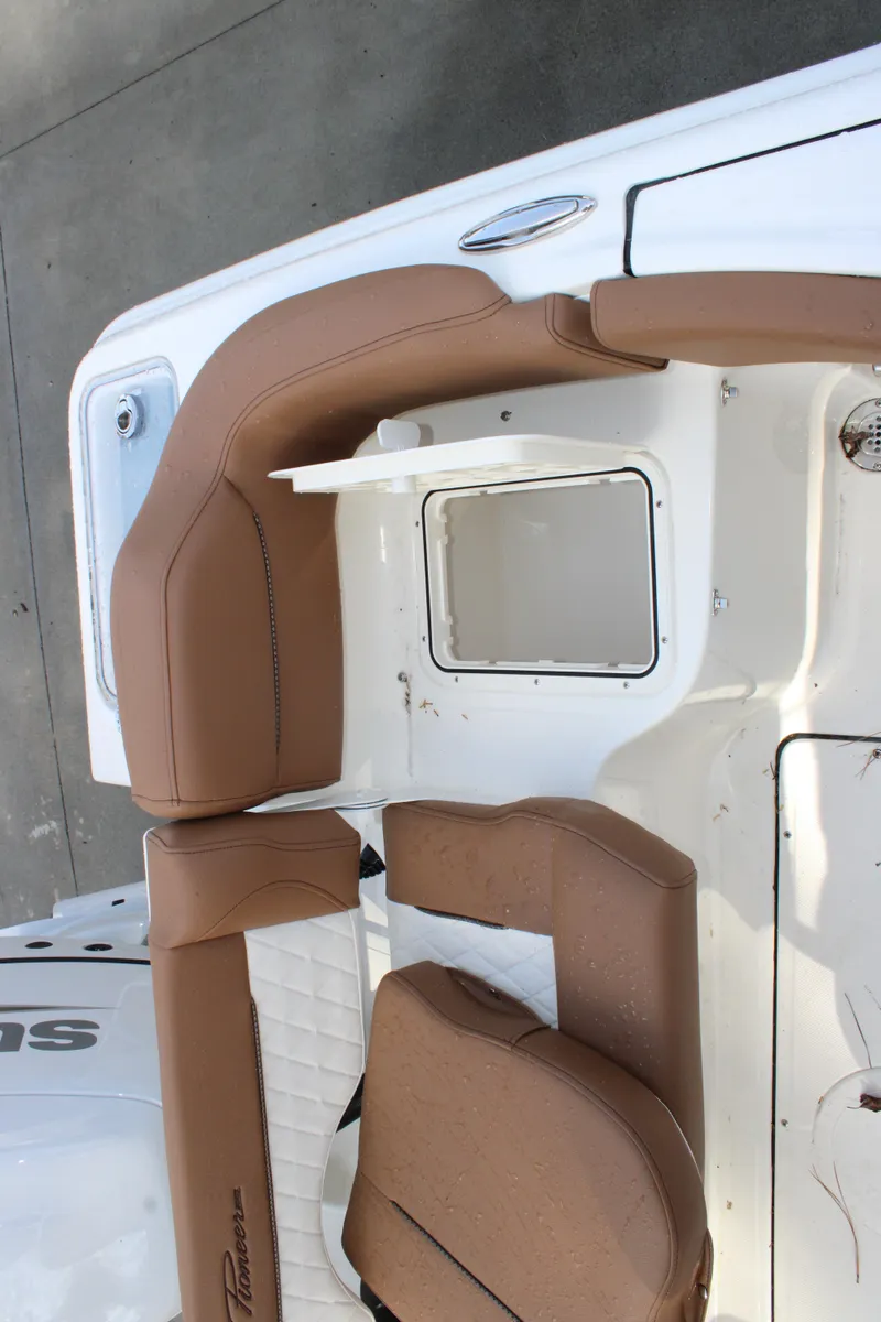 Slide: The Image of 2025 Pioneer 222 Islander boat with tan seating and white deck. - 14