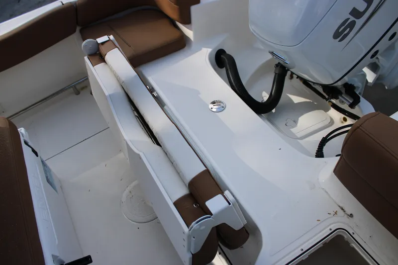 Slide: The Image of 2025 Pioneer 222 Islander boat interior with brown seating and engine area. - 15