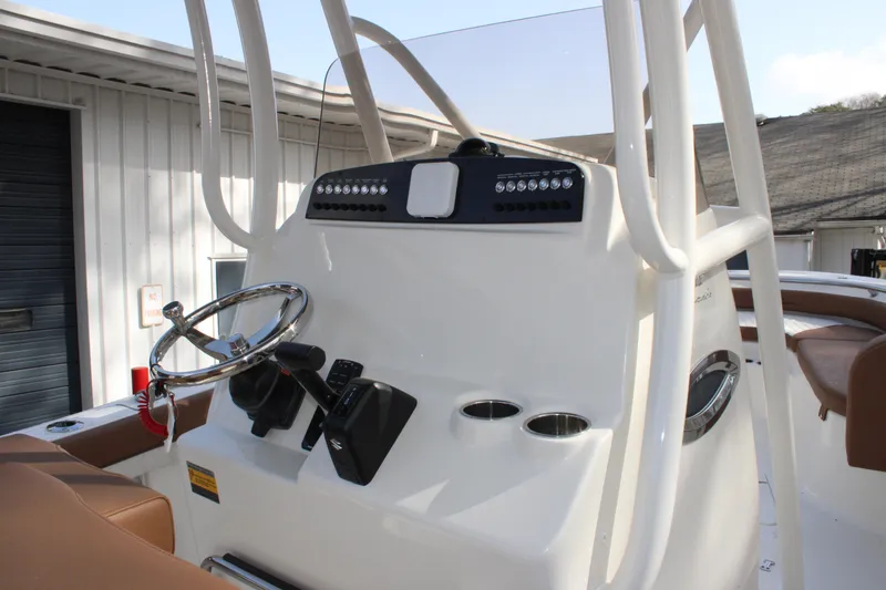 Slide: The Image of 2025 Pioneer 222 Islander boat console with steering wheel and controls. - 17