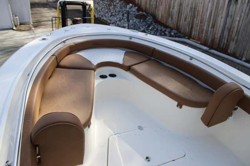 Slide: The Image of 2025 Pioneer 222 Islander boat with brown cushioned seating in the bow area. - 5