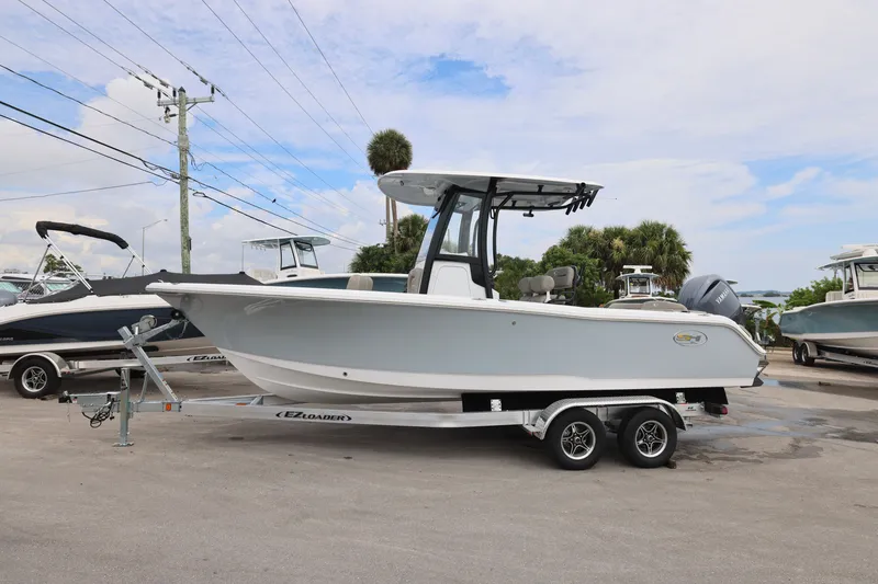 Slide: The Image of 2026 Sea Hunt Ultra 235 SE boat on trailer, parked outdoors. - 18