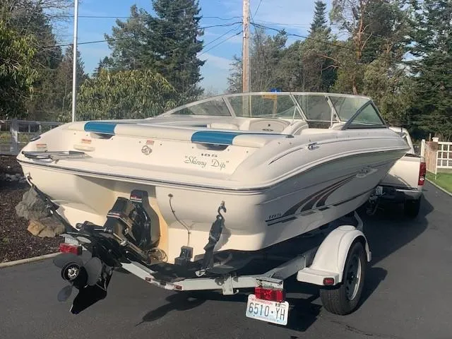 Slide: The Image of 1998 Sea Ray 185 Bow Rider boat on trailer, parked outdoors. - 2