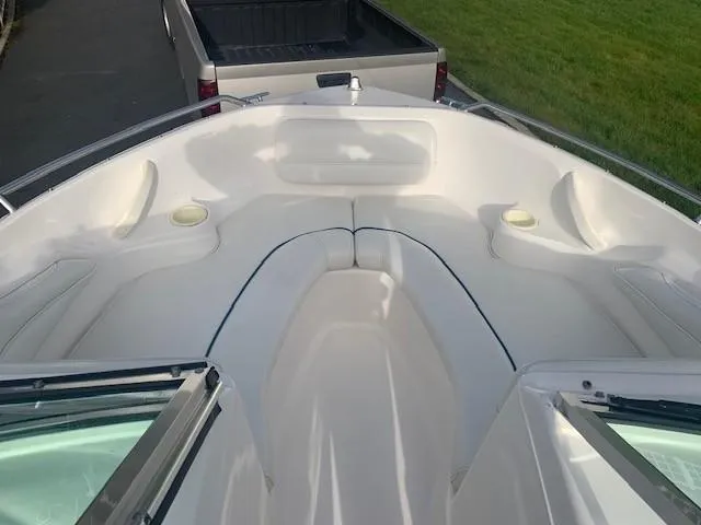 Slide: The Image of 1998 Sea Ray 185 Bow Rider boat interior with white seating and open windshield. - 7