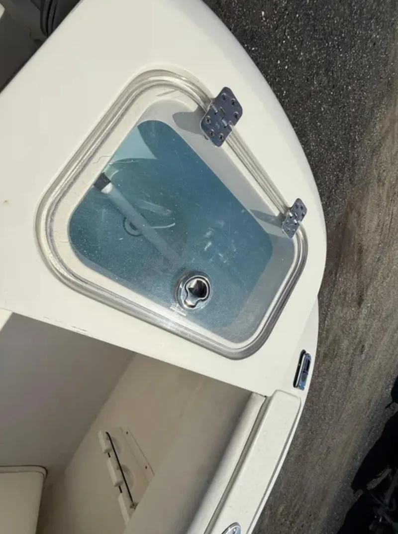 Slide: The Image of 2021 Cobia 220 Dual Console boat with a closed hatch on deck. - 17