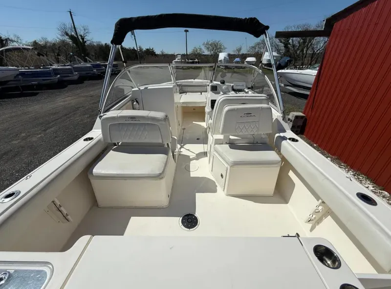 Slide: The Image of 2021 Cobia 220 Dual Console boat with spacious seating and sleek design. - 9