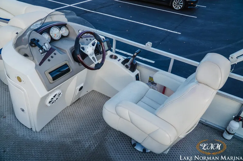 Slide: The Image of 2006 Bennington 2275 RL boat helm with steering wheel and gauges at Lake Norman Marina. - 10