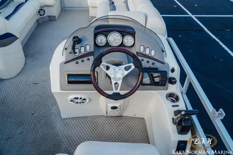 Slide: The Image of 2006 Bennington 2275 RL boat dashboard with steering wheel and controls at Lake Norman Marina. - 11